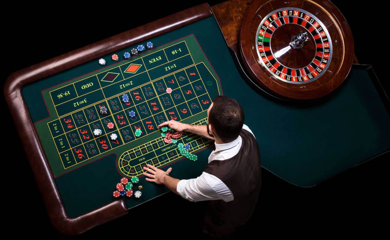  Top view of a casino dealer at a roulette table. 