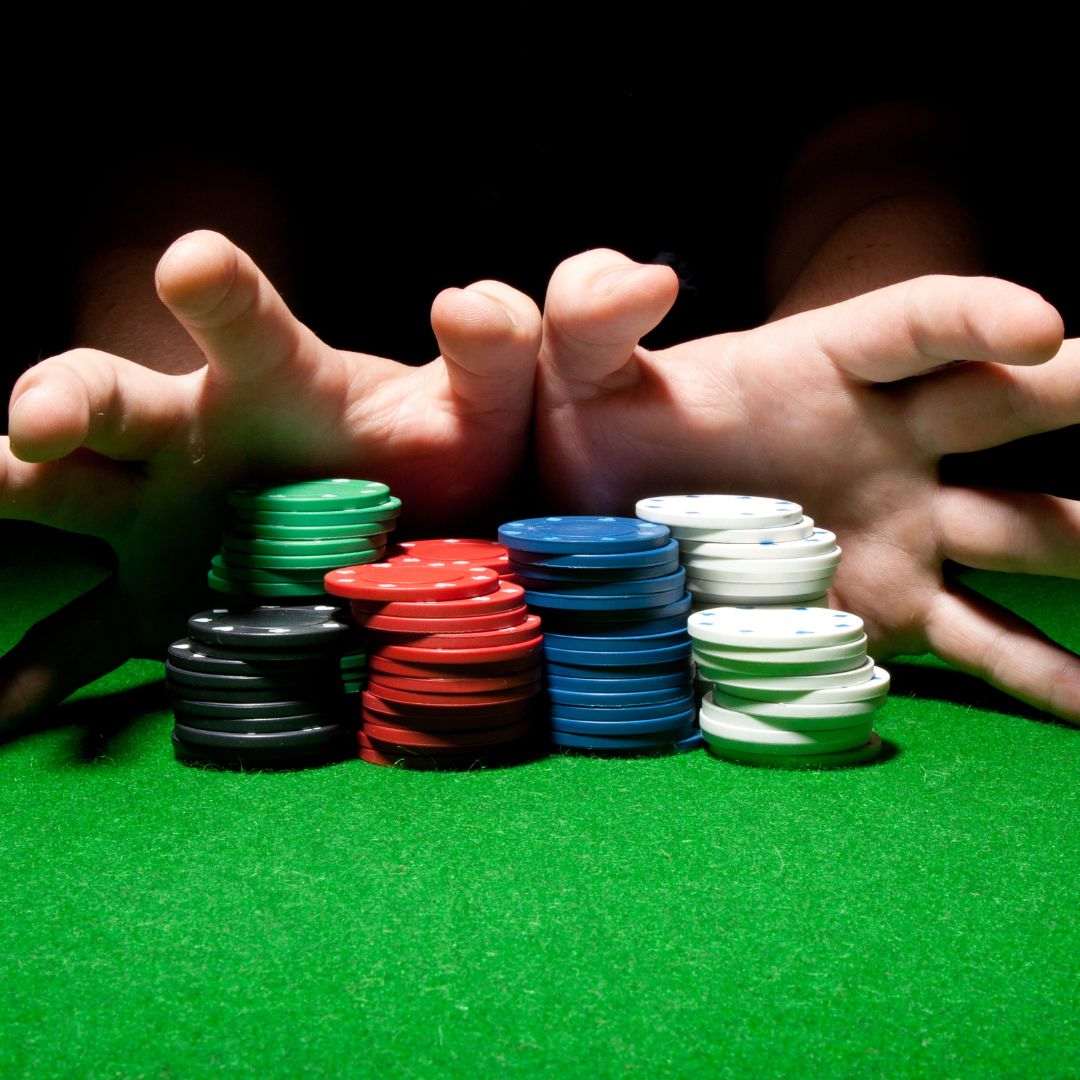 Header image, hands pushing poker chips forward on a green felt surface