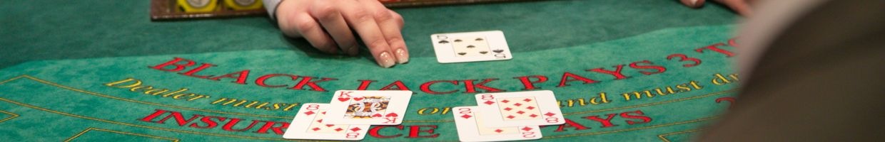 Hero image - Croupier dealing cards at a blackjack table at a casino